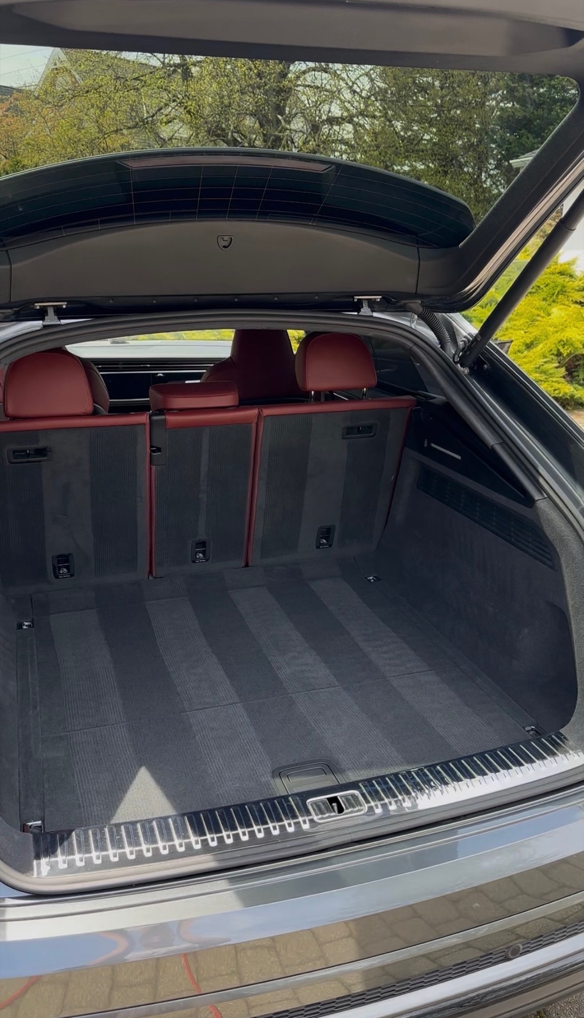 Clean cargo area and red leather seats after interior detail